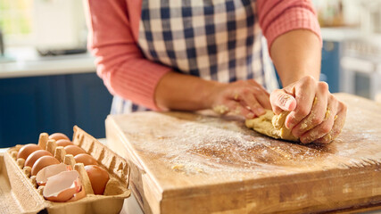 Close Up Of Woman At Home In Kitchen Making Dough On Worktop Or Counter