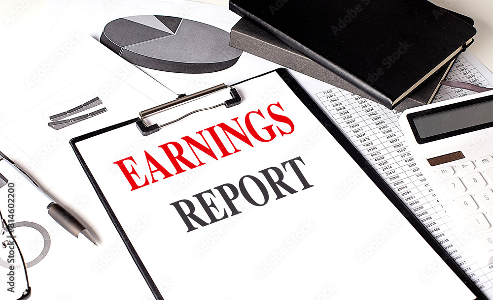 Poster earnings report text on clipboard on chart with notebook and calculator