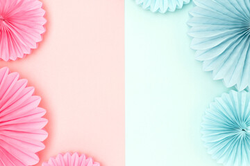 Frame made of tissue paper fans in a pink and blue colors. Gender reveal party concept with place...