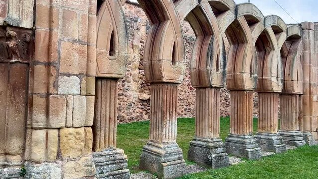 Video of a row of arched pillars with a doorway in the middle. Famous tourist area of the city of Soria, Spain. The arches of San Juan de Duero