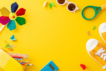 An overhead shot of vibrant school accessories arranged playfully on a bold yellow surface, depicting creativity and learning
