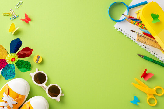 Bright and playful layout of various school supplies and children's toys scattered on a vibrant green background, indicating a creative learning environment