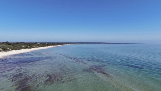 Drone footage over the sandy shoreline and scenic seascape view in Esplanade, Urangan QLD, Australia