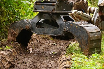 Industrial machine in an outdoor environment, with its loader extended outward, ready for use