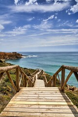 Obraz premium Beach staircase leading to the shoreline on the Atlantic coast in Ericeira, Portugal