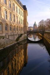 a bridge over a body of water next to a building