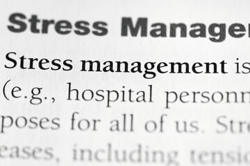 Closeup of a pychological treatment term 'Stress management' on a white paper