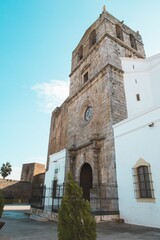 Vertical low angle shot of a historic church tower in Monsaraz, Portugal