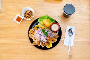 a plate of food is shown with a cup and spoon