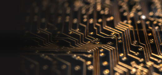 Technology background of dark printed circuit board with golden wires and pads and selective focus