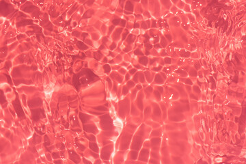 Red water bubbles on the surface ripples. Defocus blurred transparent pink colored clear calm water...