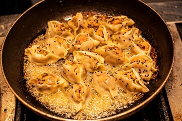 the dumplings are cooking in the skillet on the stove