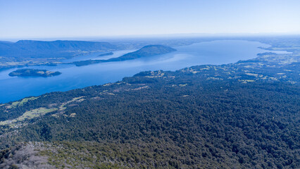 an aerial view of a large body of water near trees