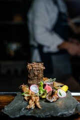 Close-up of delicious food served placed on a table in front of a person