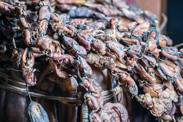 Close-up of a basket filled with dried seafood strung up on strings