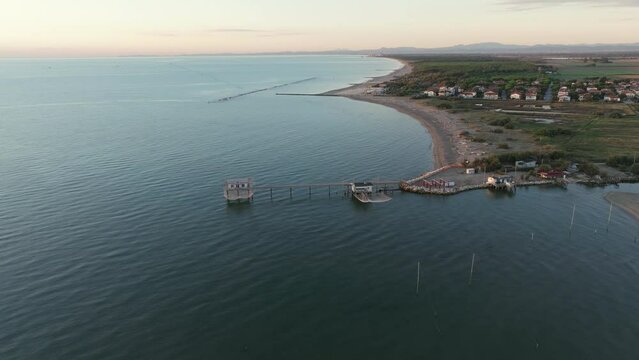 Aerial view of fishing huts on the shores of the estuary at in Lido di Dante, Ravenna, Comacchio