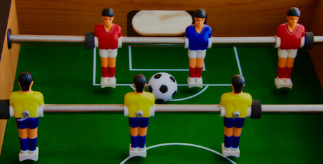 Table football game with yellow and red players and blue goalkeeper. Table soccer game, Foosball...
