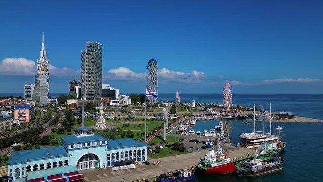 Drone shot of Batumi Marine Station and urban buildings standing on Black Sea coast, Batumi, Georgia