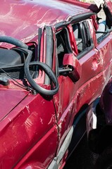 Red damaged car after an accident or a crash