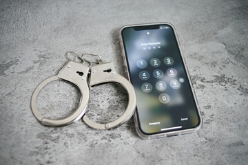 Data Security. Handcuffs And Lockscreen Smartphone Isolated on Gray Background. 