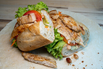 sandwich with chicken, cucumber and tomato