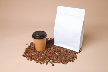 White Standing Pouch And Coffee Cup Mockup For Advertisement With Coffee Beans Over Brown Background