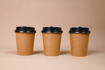 Arrangement Of Standing Cup Coffee Over Brown Background