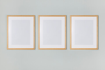 Three empty picture frames hanging on the wall