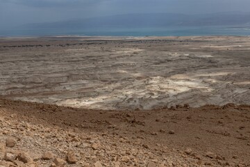 view from the mountains looking down into the desert at the dead sea