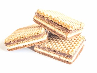 Halves of waffle sandwiches placed on a white background, with the left side of the image in focus