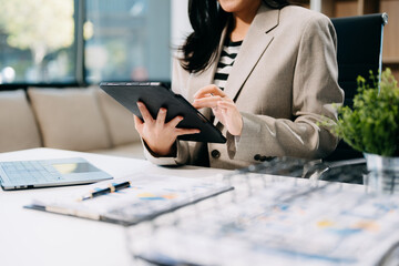 Confident businessman working on laptop,tablet and smartphone at her workplace