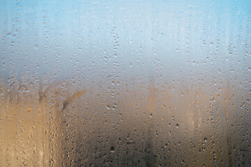 Water drops on the window, natural background, closeup of photo