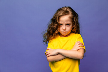 Negative human emotions, reactions and feelings. Isolated shot of moody upset little girl crossing...