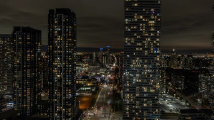 a city with tall buildings in it and lights on at night: Mississauga