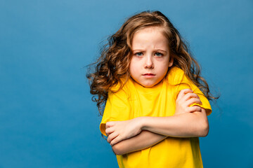 Negative human emotions, reactions and feelings. Isolated shot of moody upset little girl crossing...