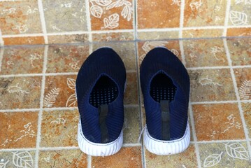 A pair of dark blue shoes on the floor