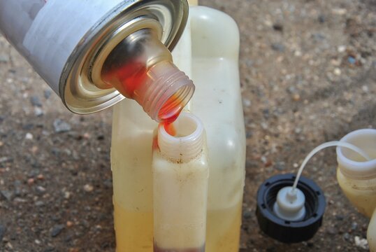 prepare the fuel mixture for a trimmer or chainsaw close-up. selective focus. blurred background