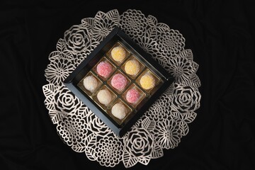 a decorative table with six trays of food inside of it