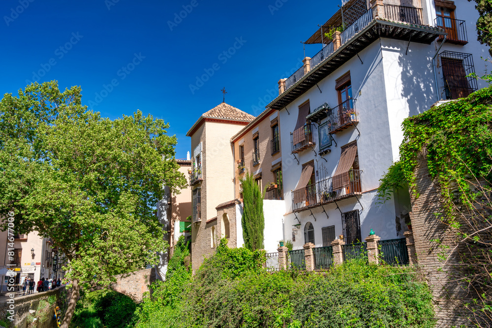 Poster Granada, Spain - April 13, 2023: Tourists along the city streets