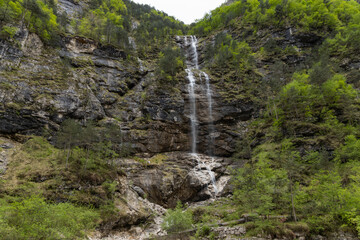 Rio di Repepeit. Wonderful waterfall that falls from a cliff. The force of the waterfall is a sight to behold. Hiking, trekking in the open area surrounded by woods. Summer holidays, peace.