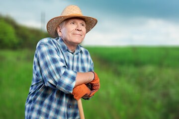 Portrait of smiling man farmer standing in field,