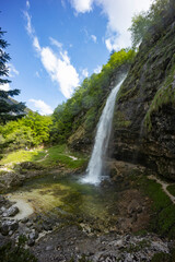 Fontanon of Goriuda, Udine. Wonderful waterfall that falls from a cliff. The force of the waterfall...