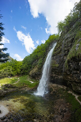 Fontanon of Goriuda, Udine. Wonderful waterfall that falls from a cliff. The force of the waterfall...