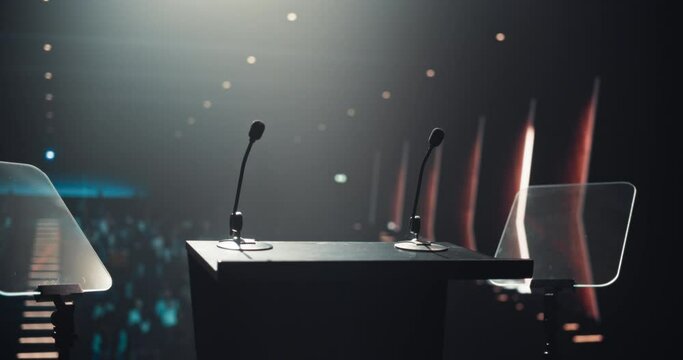 Sophisticated Conference Stage With Two Microphones Under Spotlights, Ready for a Speaker to Come Up on Stage in a Dimly Lit Auditorium. Public Speaking and Conference Presentation Concept
