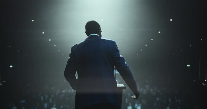 Anonymous Black Personal Growth Keynote Speaker Delivering a Motivational Speech on Stage, Hosting a Psychology Seminar to Help Entrepreneurs Overcome Their Personal and Professional Challenges