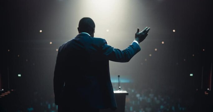 African Speaker with Expertise in Technology, Finance, Business, Politics, and Religion Coaching a Diverse Group of Young Specialists During a Presentation at a Strategic Growth Conference