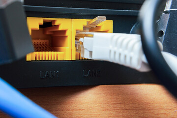 A Wi-Fi wireless router with connected network and power cable. Home and office wlan router with...