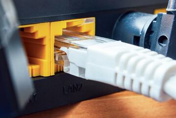 Home and office lan router with inserted internet white cable. Wi-Fi wireless router with connected...