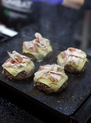 grilled beef burgers, melted cheese and bacon