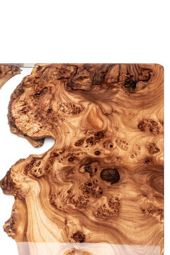 Live edge elm burl slab table top with central epoxy resin river on white background, combining natural wood with a synthetic material